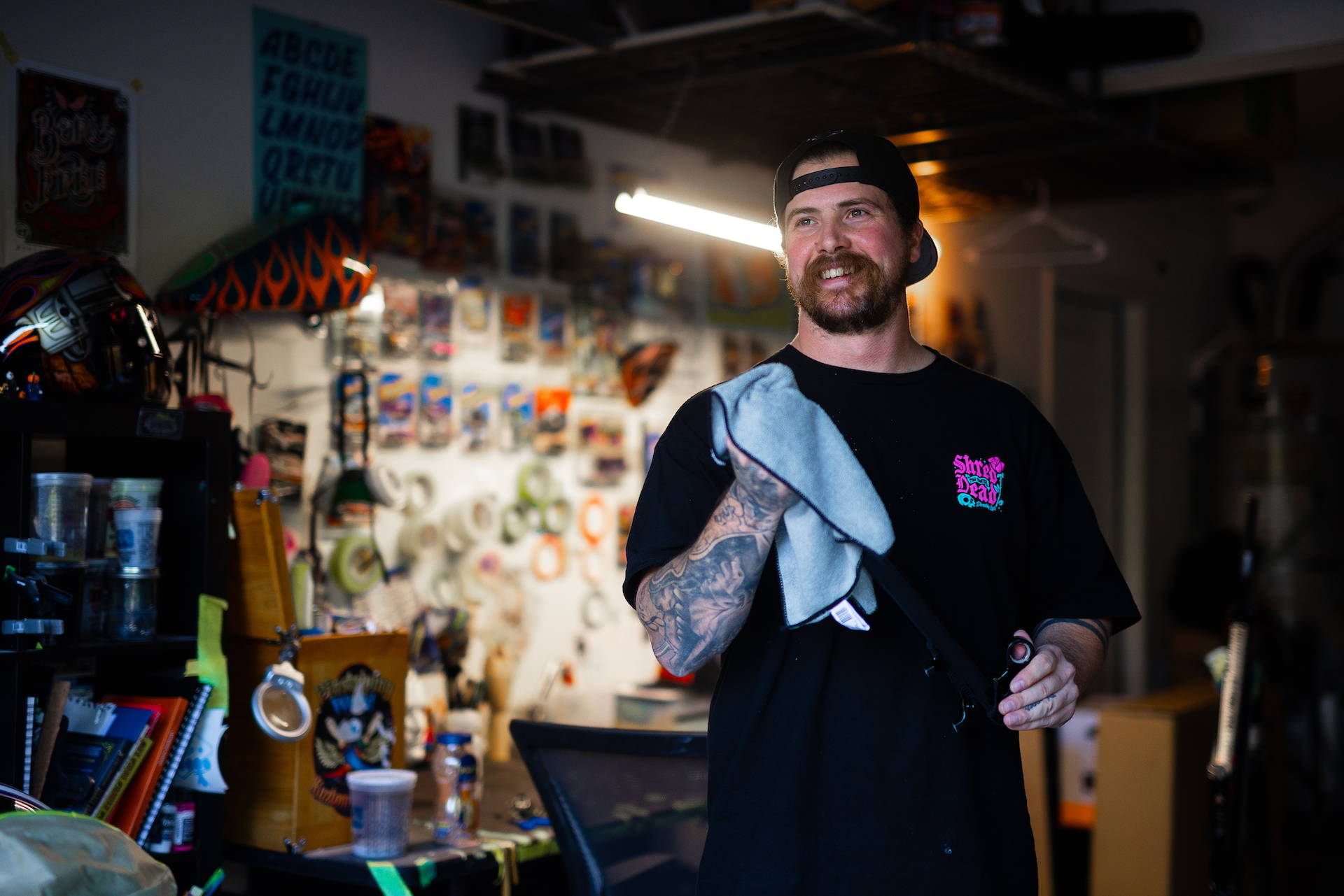 Painter Jake Wilkins of Cathedral with Kyle Strait's custom Red Bull Rampage 2023 bike