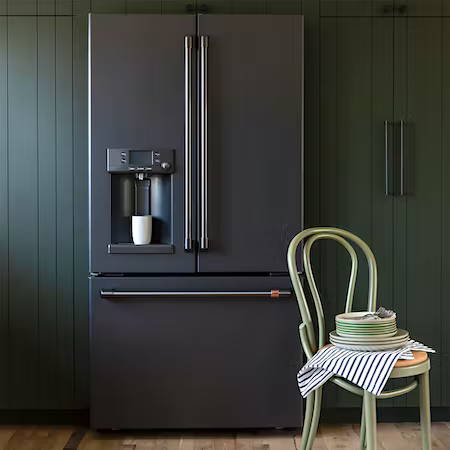 matte black French door refrigerator in sage green cabinets