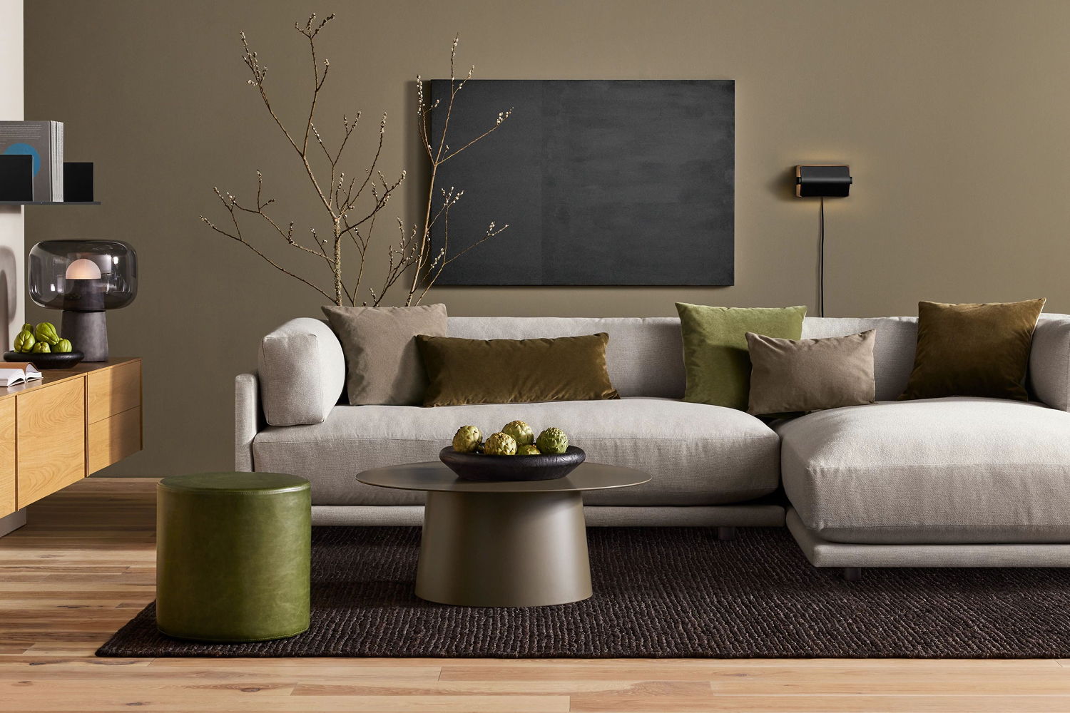 Modern living room with a sofa, decorative pillows, and a wooden accent table.