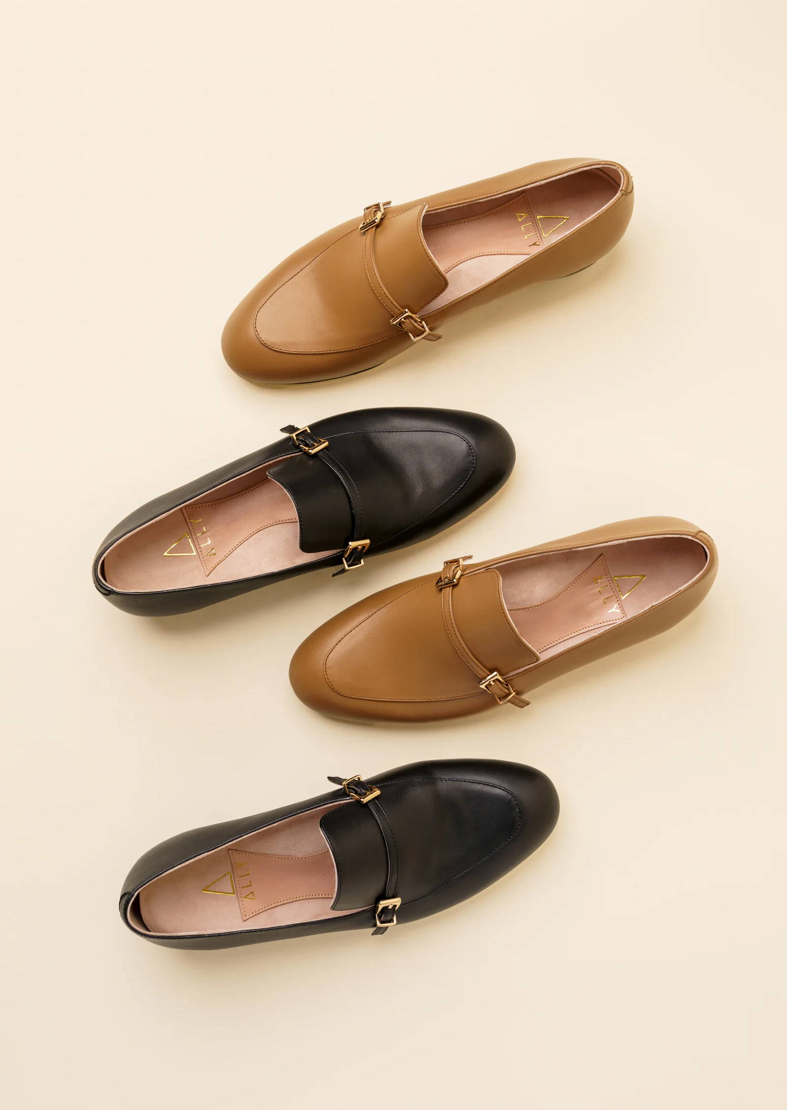 Aerial view of two pairs of loafers in tan and black colors.