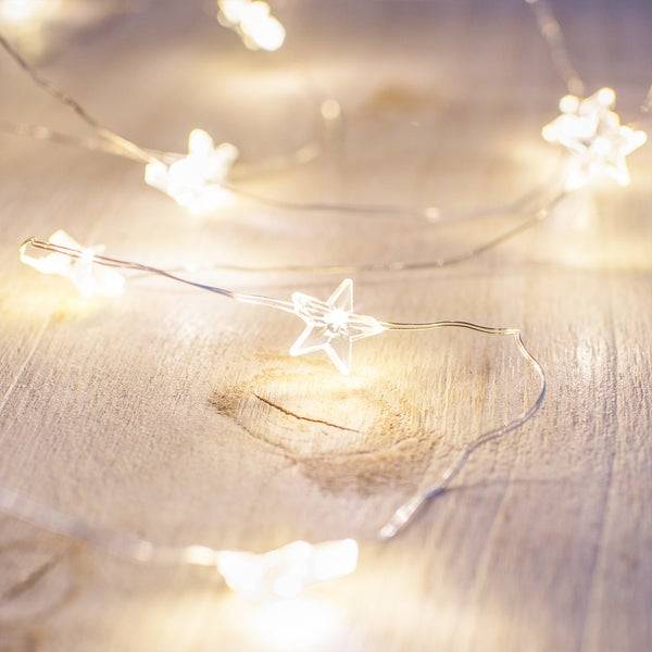 Close up star micro lights on a wooden surface.