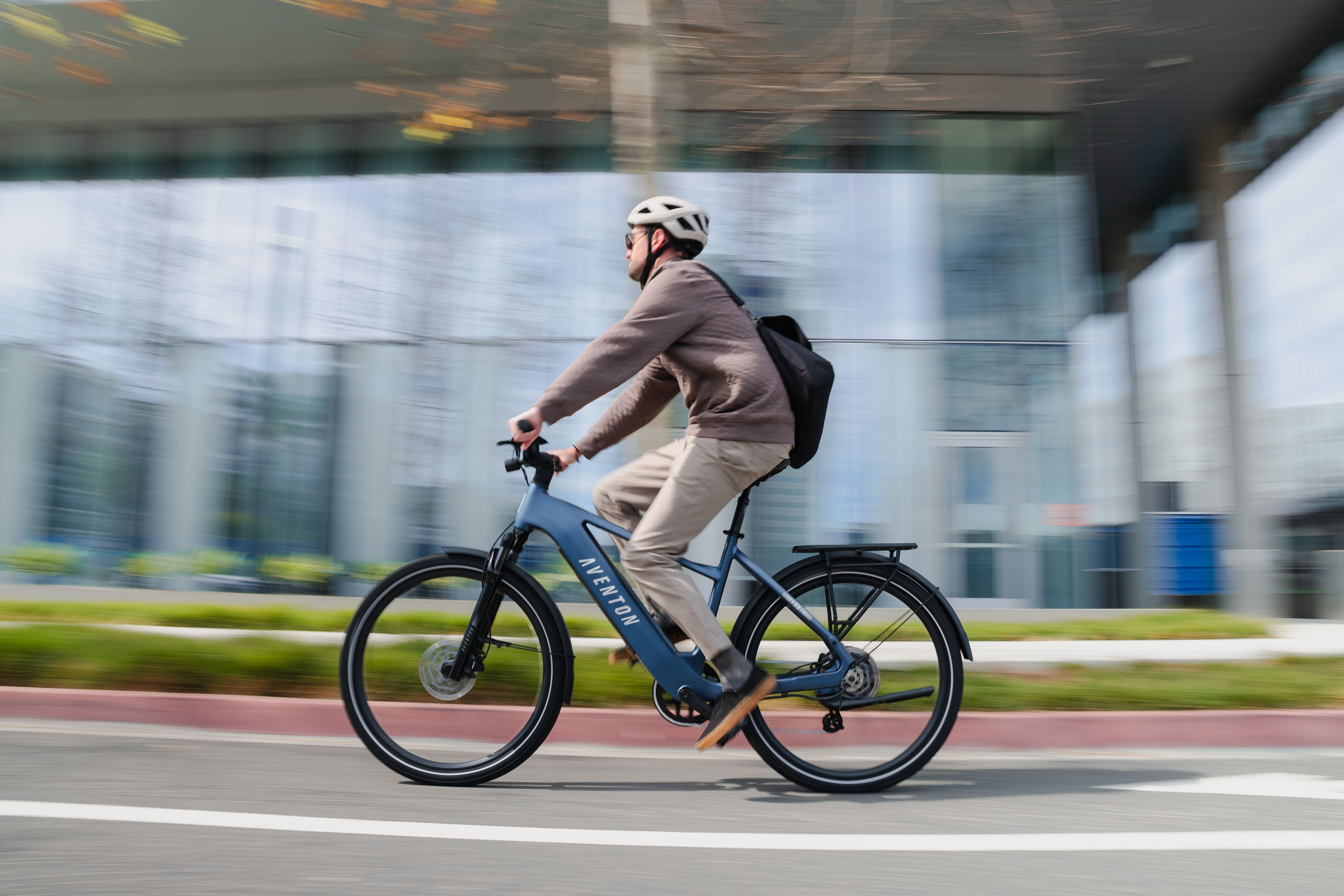 Person riding an electric bike on a city street.