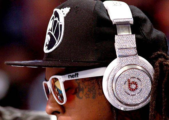  Hip Hop mogul wearing a pair of modified Beats  by Dr Dre headphones covered with diamonds | Credit: https://slate.com