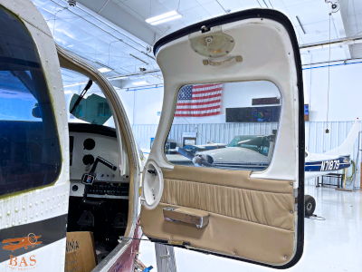 Interior view of an aircraft door with an American flag in the background.