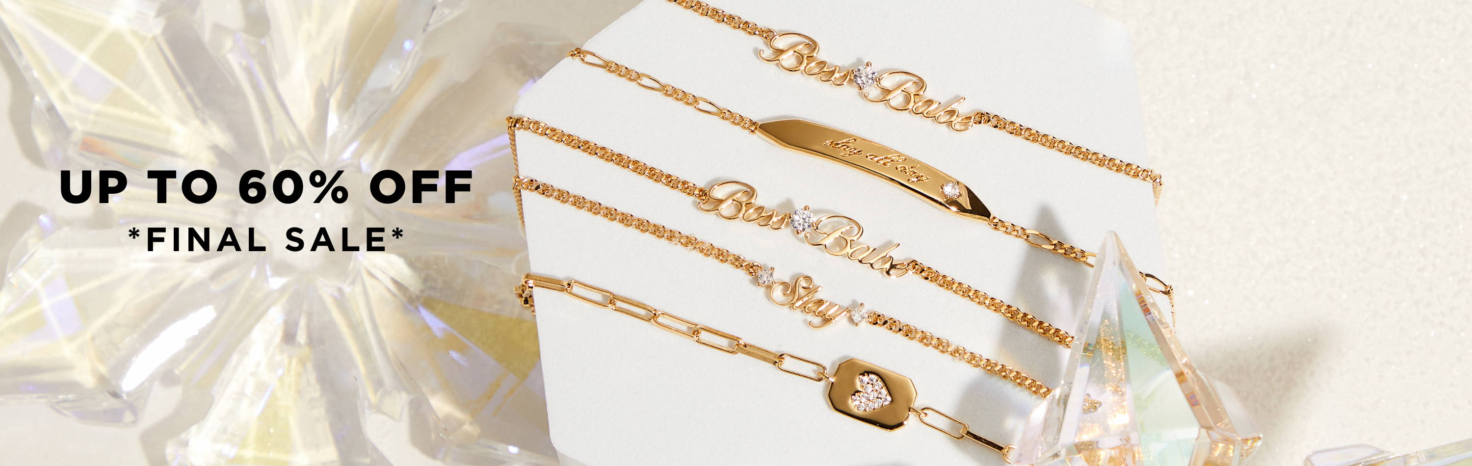 Up to 60% off. Finale Sale. Image of a flat lay featuring  gold chain bracelets)