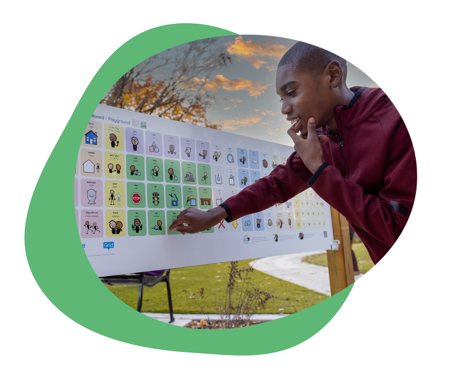 Child interacting with a colorful chart outdoors, deep in thought.