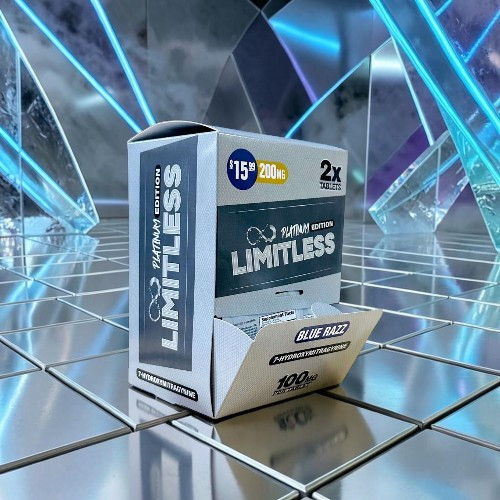 Box of LIMITLESS products on a reflective surface with geometric background.