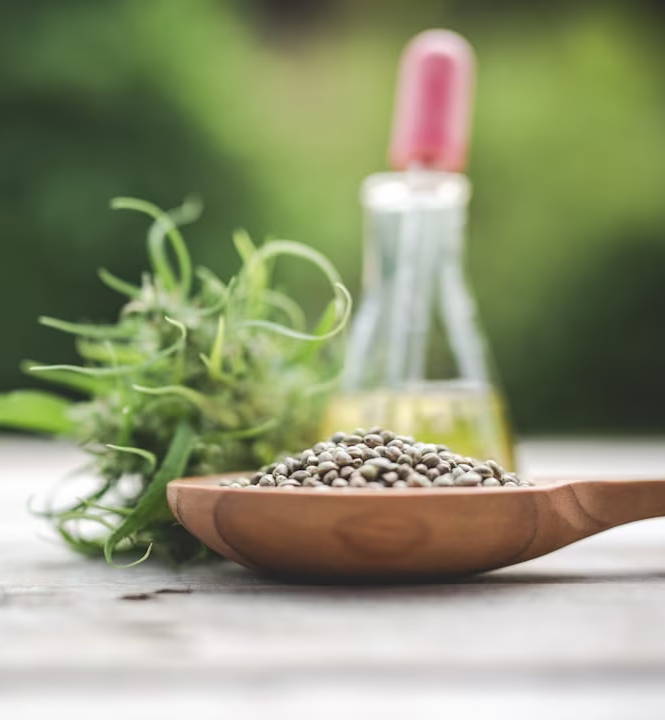 selective focus photography of ladle of powder beside bottle on brown table