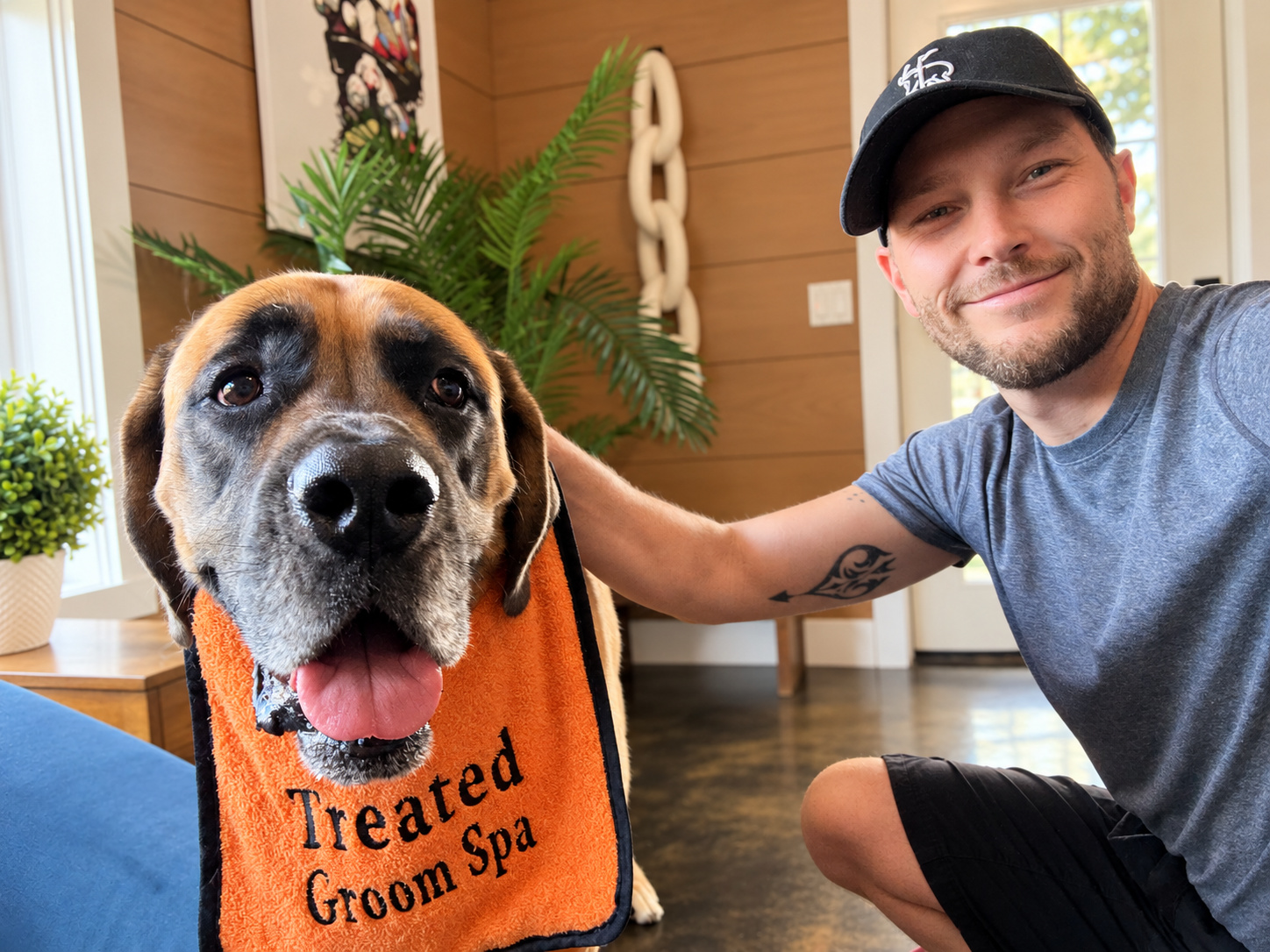 Kyle Neumann, co-owner of Treated Groom Spa, with a dog in the salon