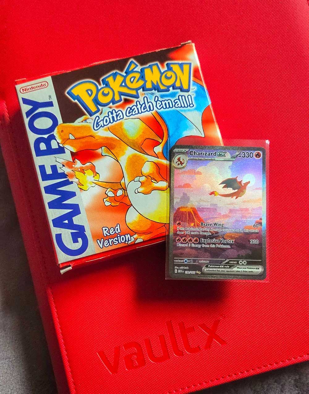 Pokémon Game Boy game box and trading card on a red surface.