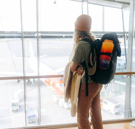 A girl with a backpack at an airport