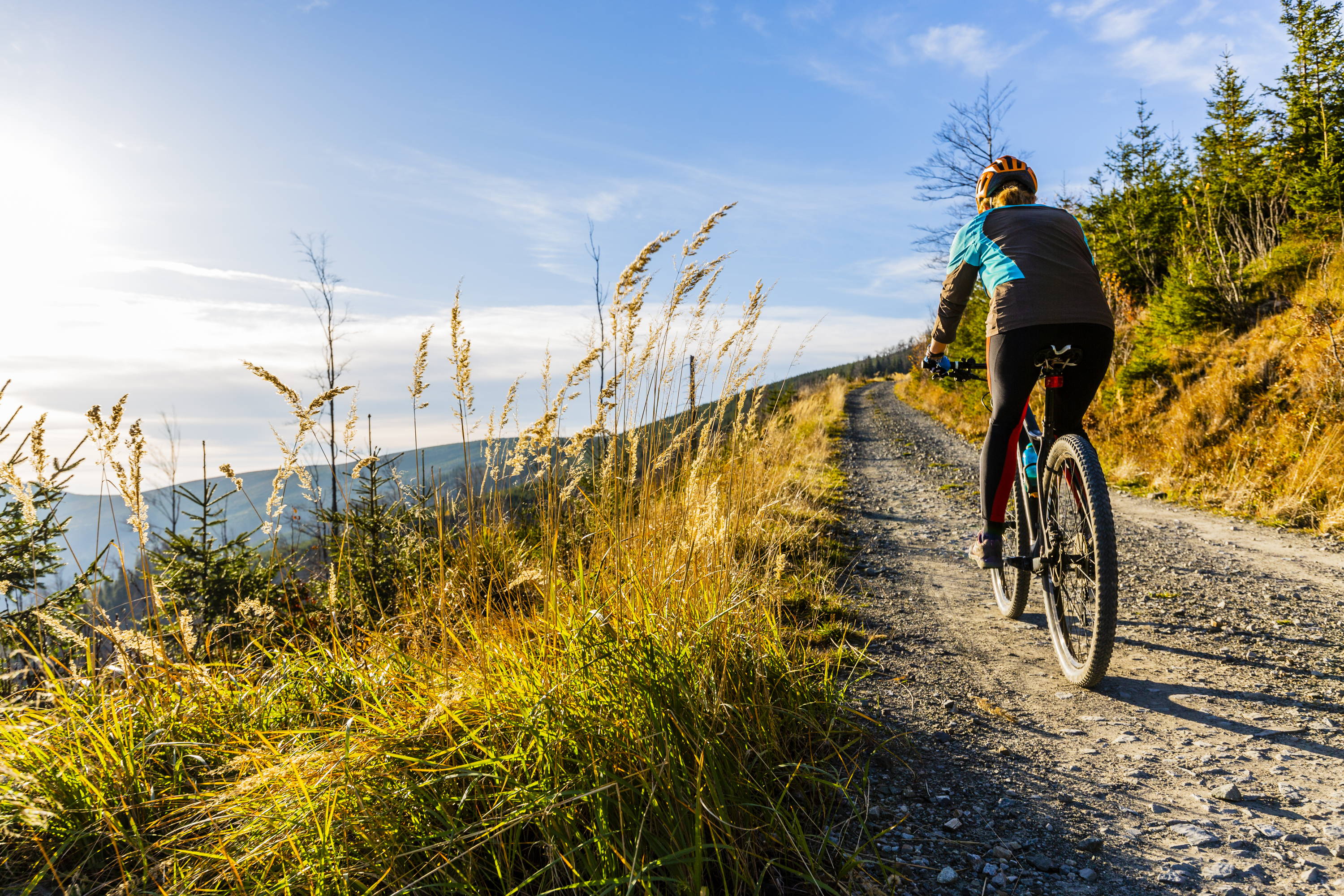 Woman on mountain bike, outdoor exercise, woman wearing compression