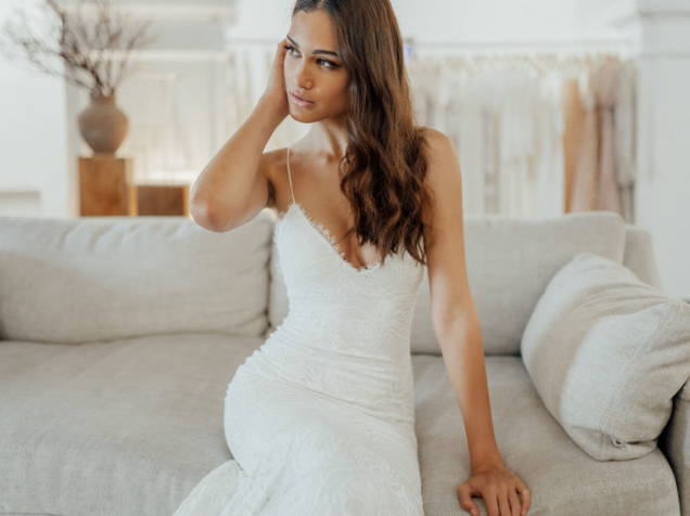 Bride seated on the sofa wearing the Grace Loves Lace Clo wedding dress 