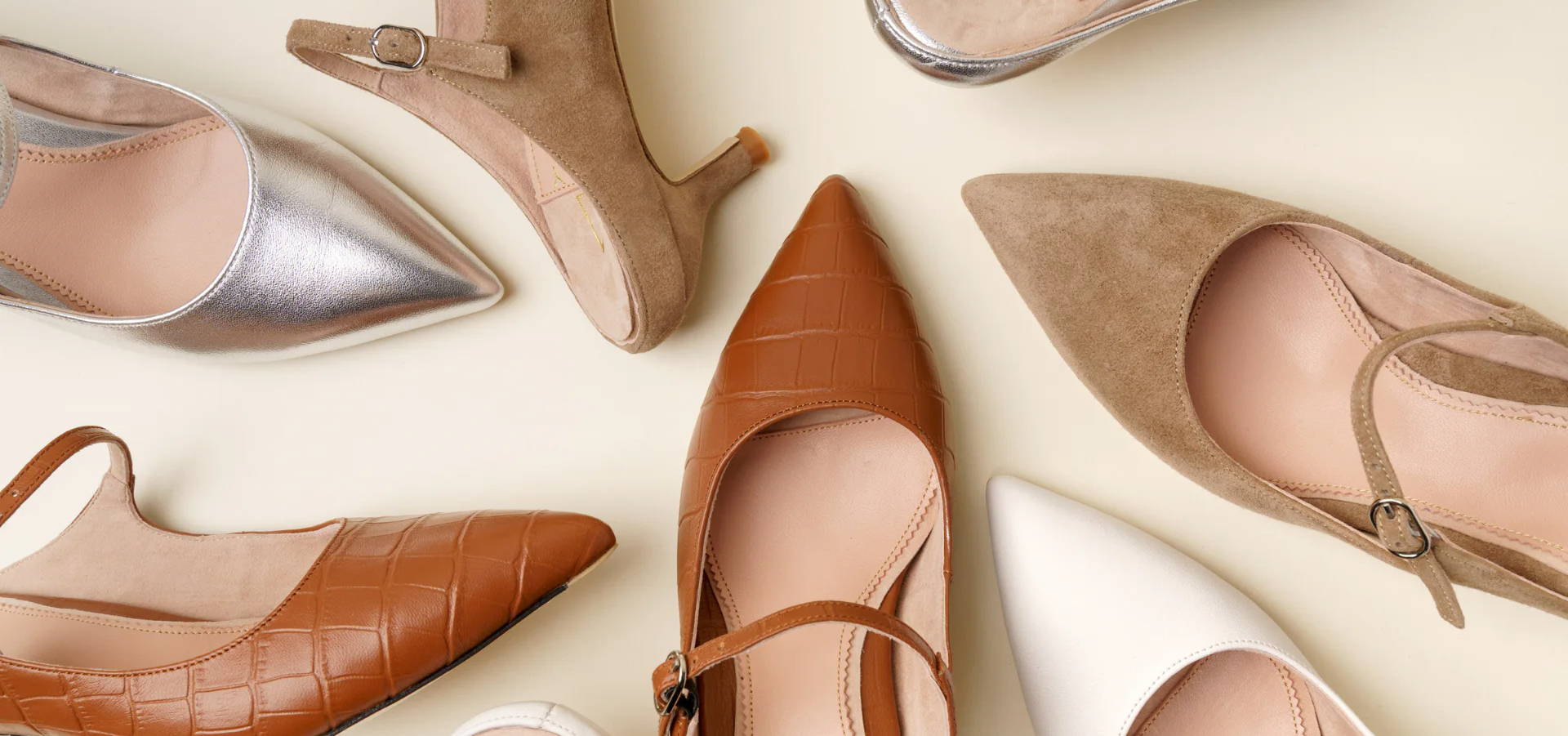 A collection of various stylish high-heeled shoes arranged in a circular pattern.