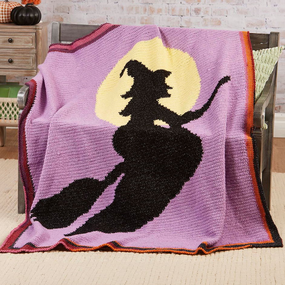 A graphgan featuring a witch silhouette against a purple background and moon.