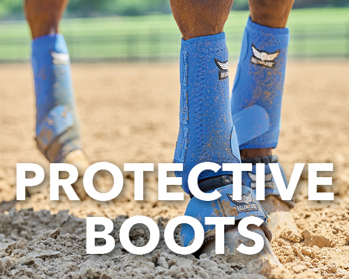Person wearing blue protective boots on sandy ground.