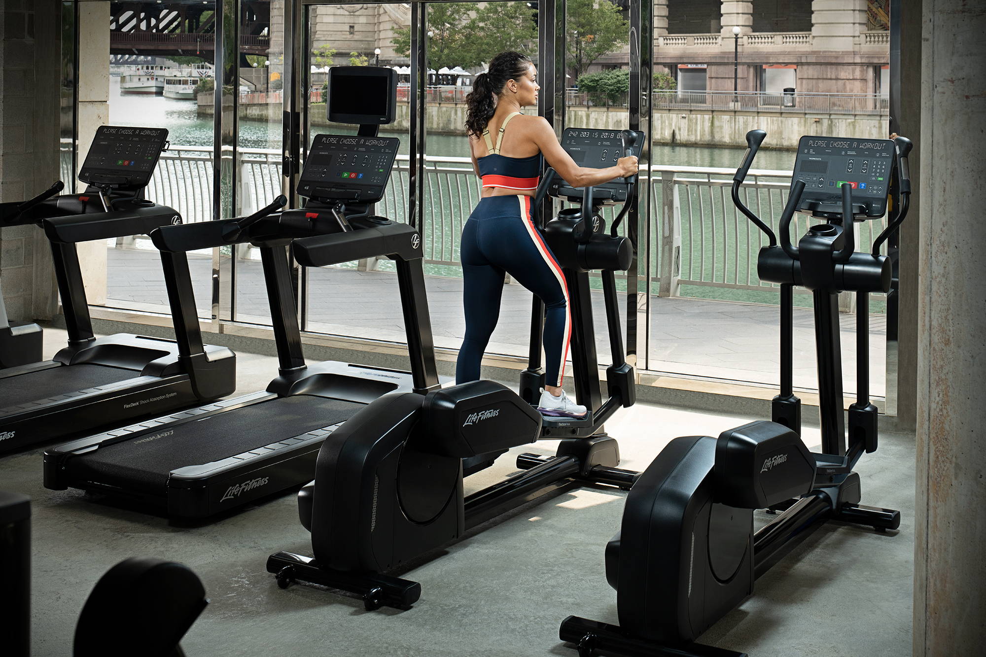 Female exercising in gym on Club Series+ Elliptical