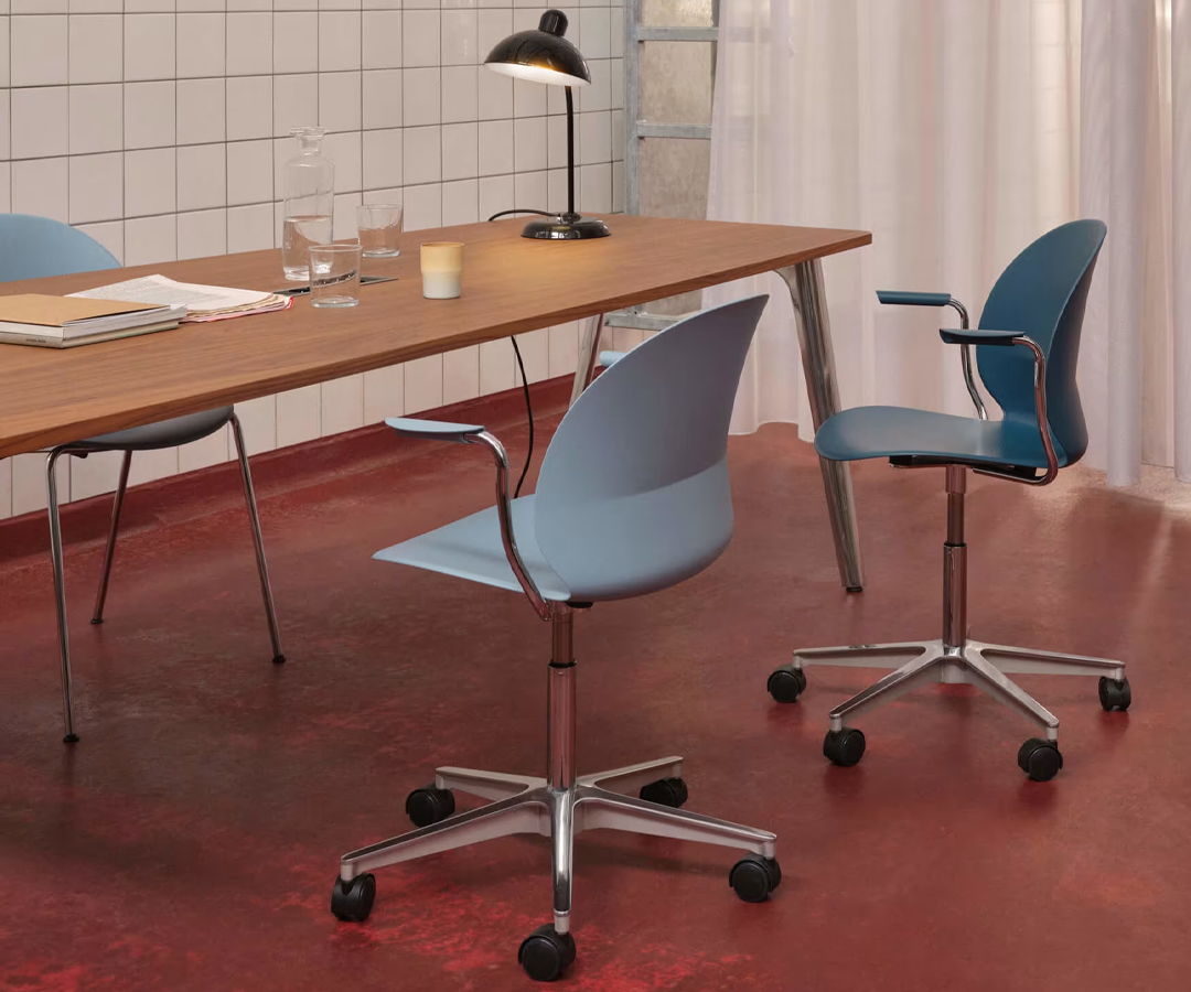 A modern Fritz Hansen workspace with blue N02 chairs and a wooden table.