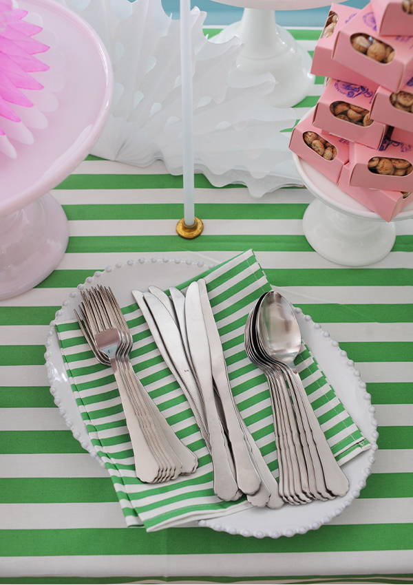 Cutlery laid on a green and white striped napkin