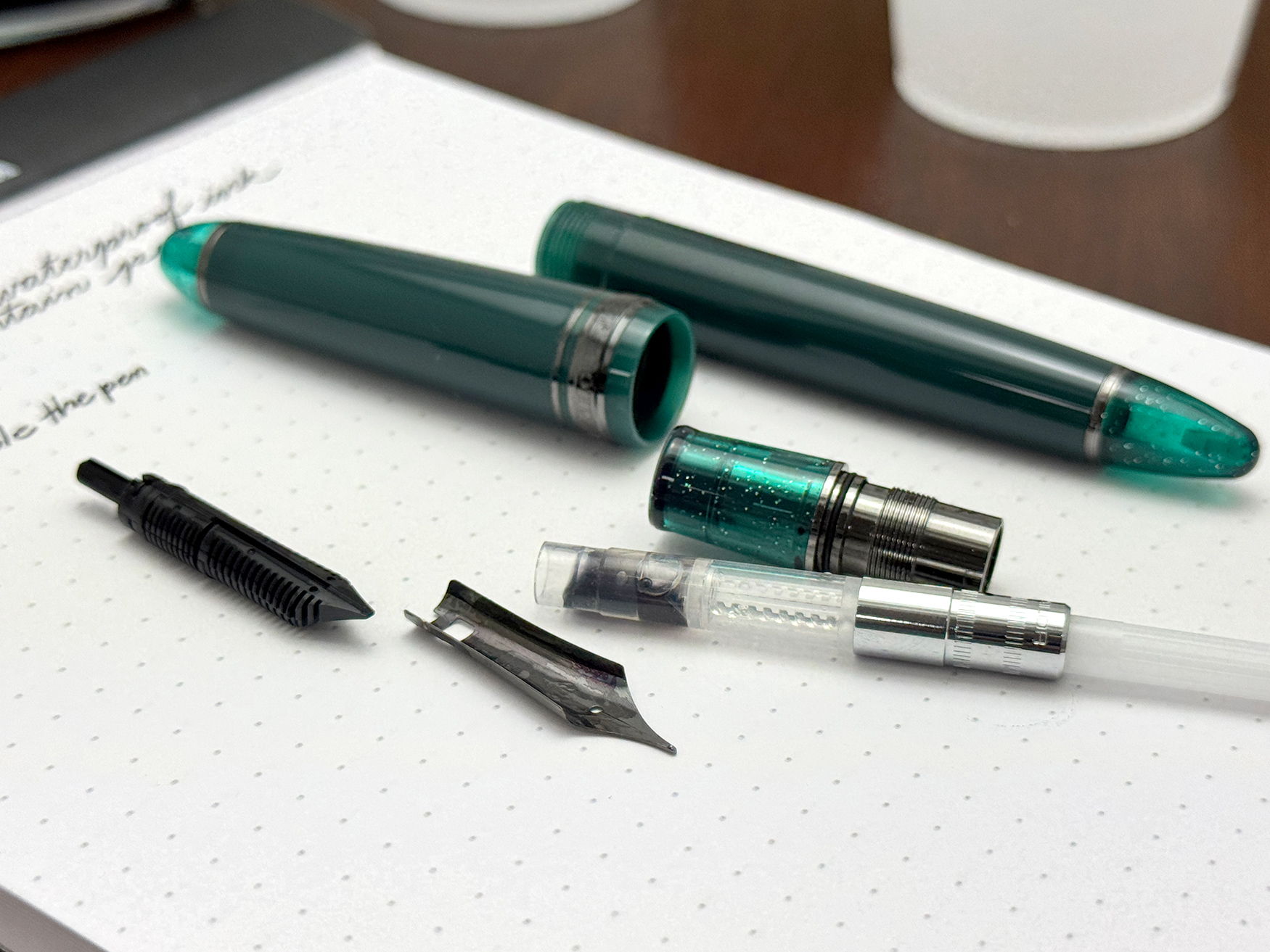 Sailor 1911 L Call of Cthulhu Fountain Pen disassembled on a rhodia notepad