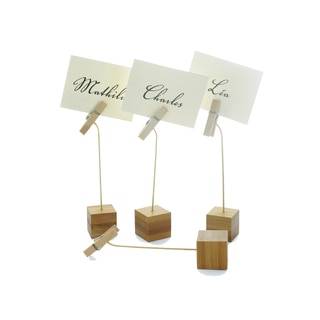 Several small wooden sign holders consisting of a block end and a clothespin on the other side
