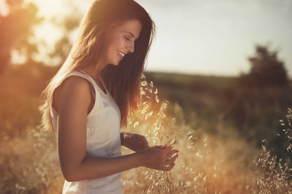 woman in field smiling grow new adult brain cells