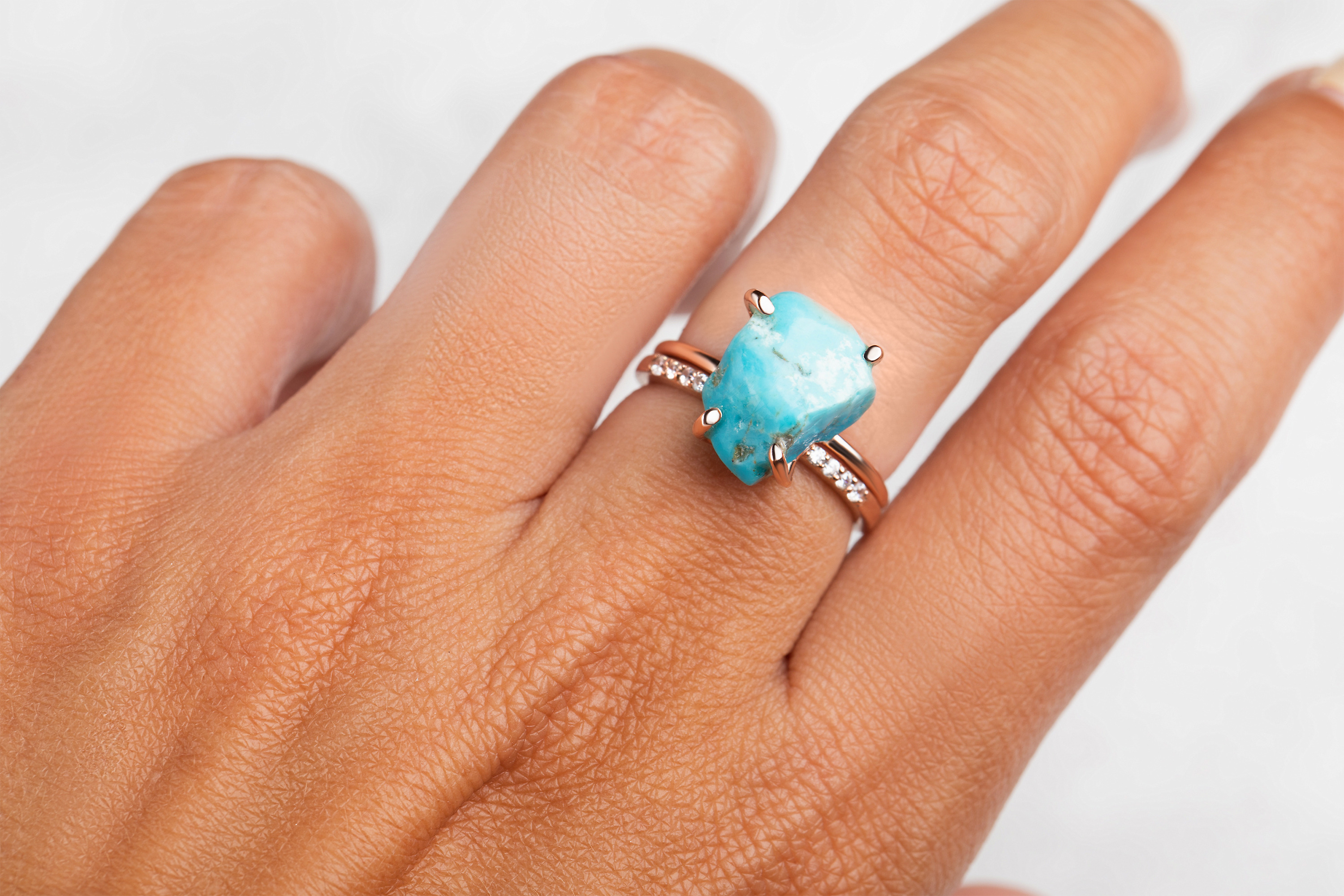 The Raw Crystal Ring Aquamarine is presented with another stackable ring on a woman's hand.
