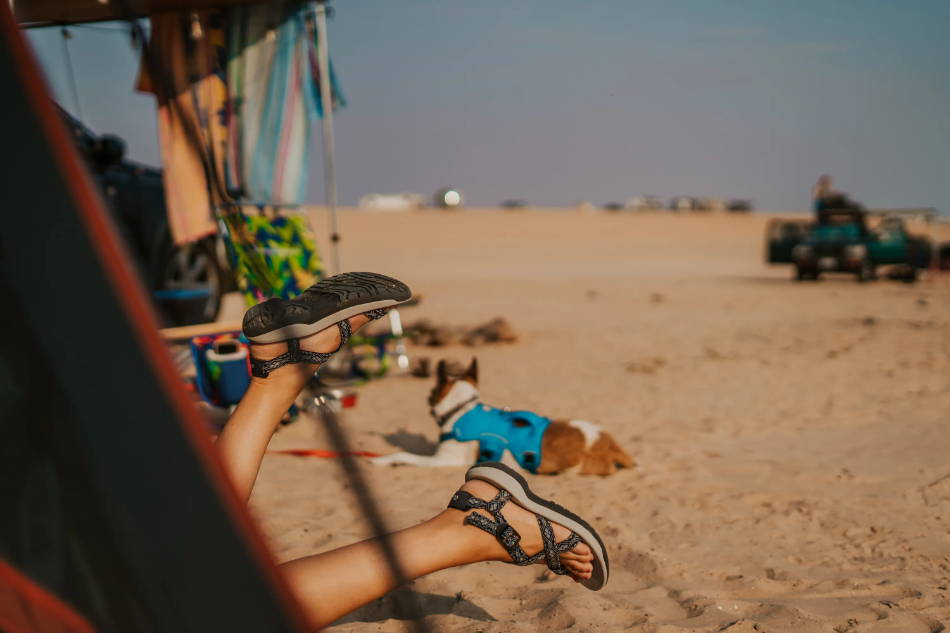 woman wearing trekking sandals on a beach in the caribbean