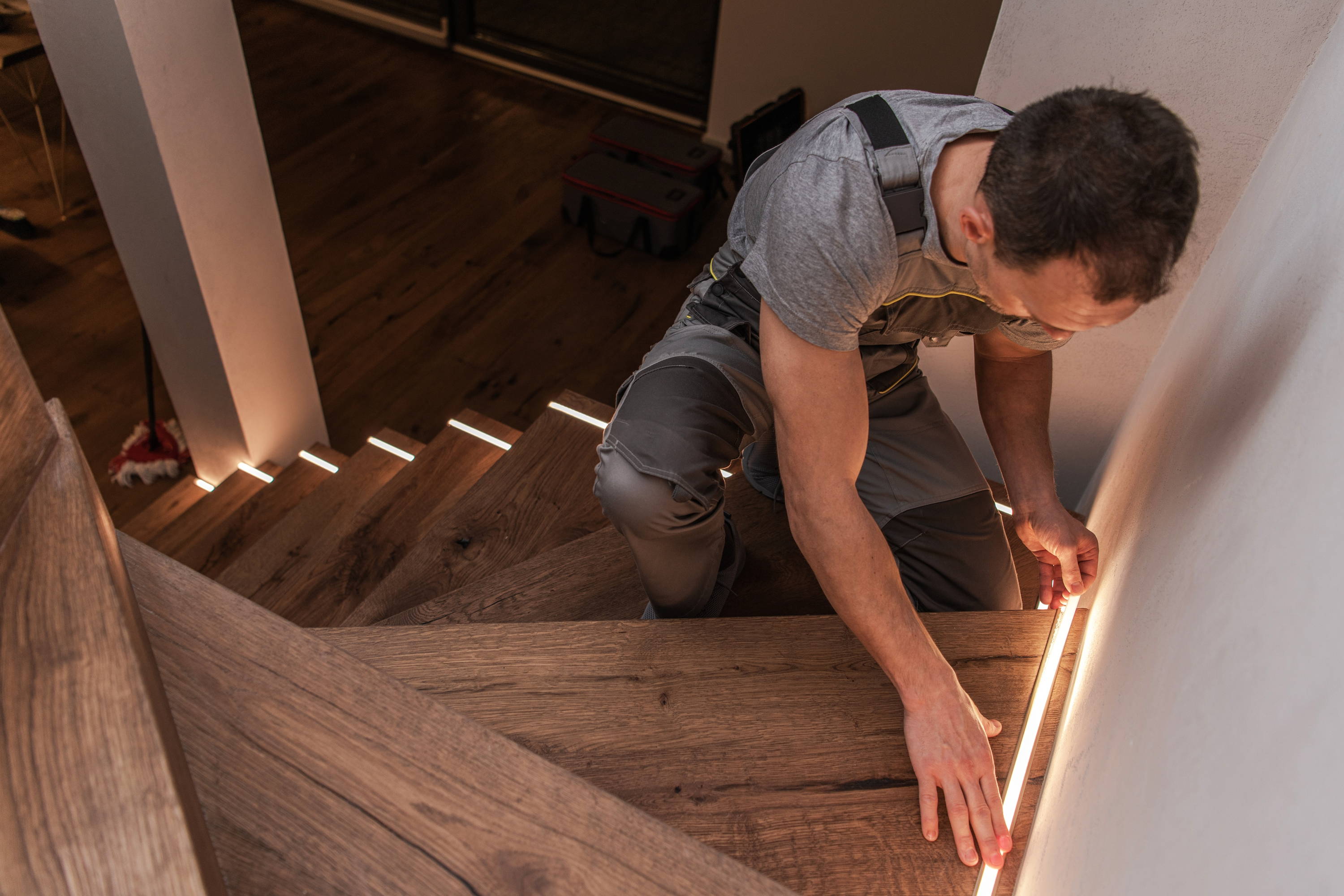 contractor installing LED stairway lighting