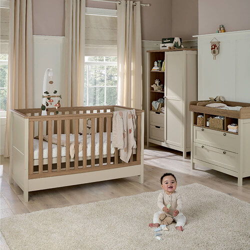 A cozy nursery with a crib, changing table, and a baby on the floor.