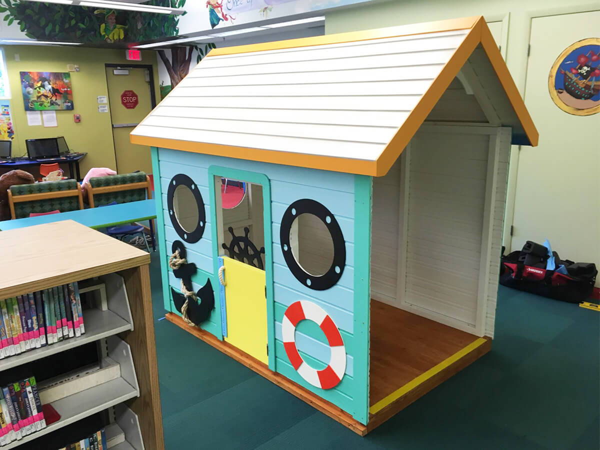 Custom playhouse in a library in marine theme by WholeWoodPlayhouses