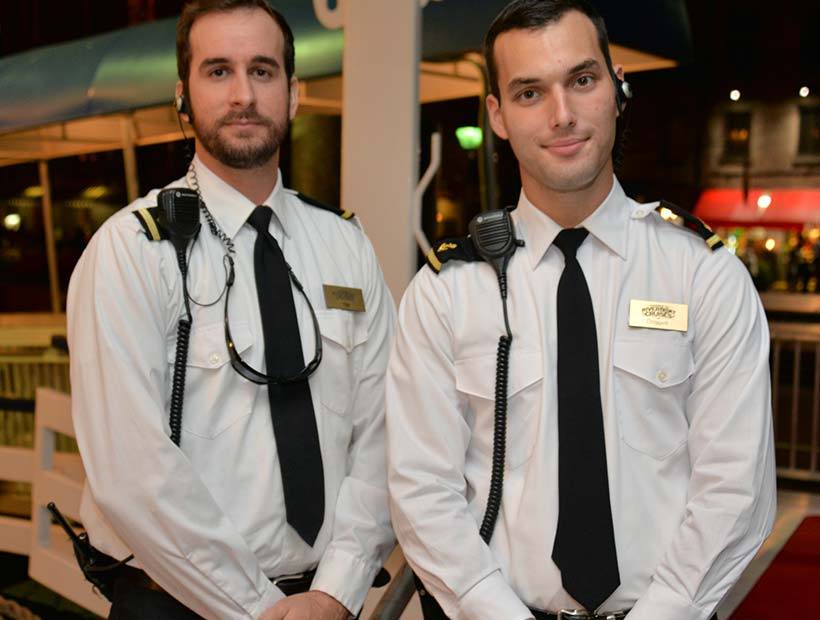 Two male marine crew wearing white dress shirts, epaulets and black uniform ties