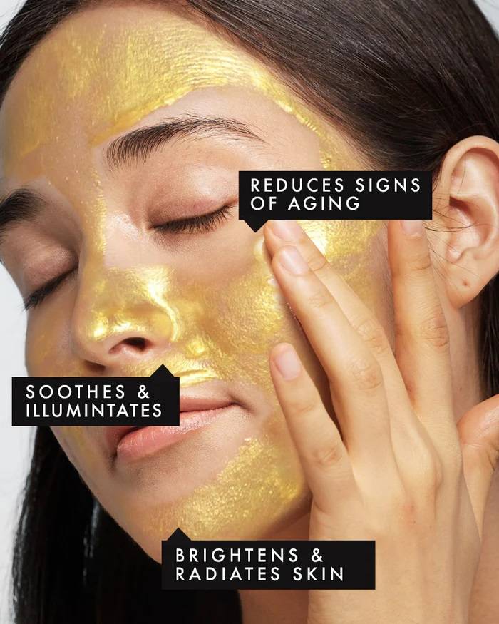 Lady wearing gold peel of mask , benefit reduces sign of agin , soothes and illuminates and brightens & radiates skin 