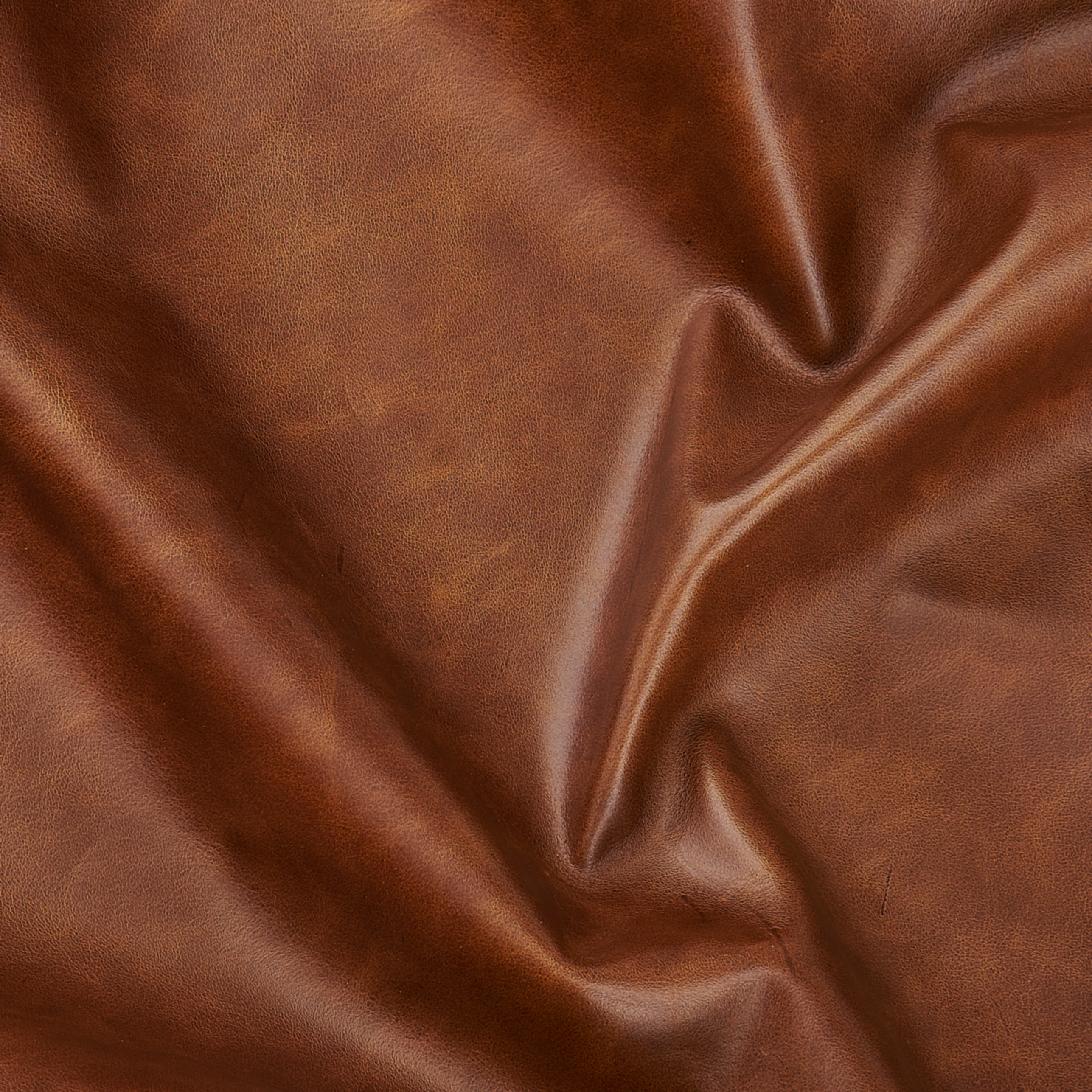 Close-up of waxy pull-up leather in Mocha color, showing rich brown tones, natural creasing, and a soft, slightly glossy finish.