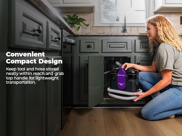 Woman storing spot cleaner in cabinet under kitchen sink. Text about convenient compact design.