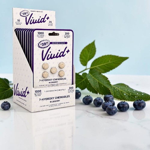 Vivid+ blueberry-flavored chewable tablets pack with fresh blueberries and leaves.