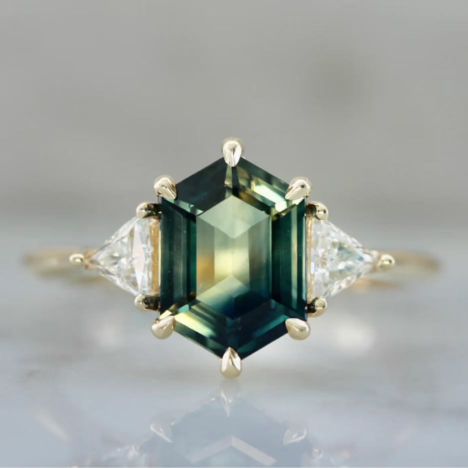 Custom engagement ring with hexagon shaped green sapphire and trillion diamond side stones by Gem Breakfast