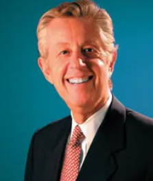 Photo of a smiling blonde Man wearing a suit