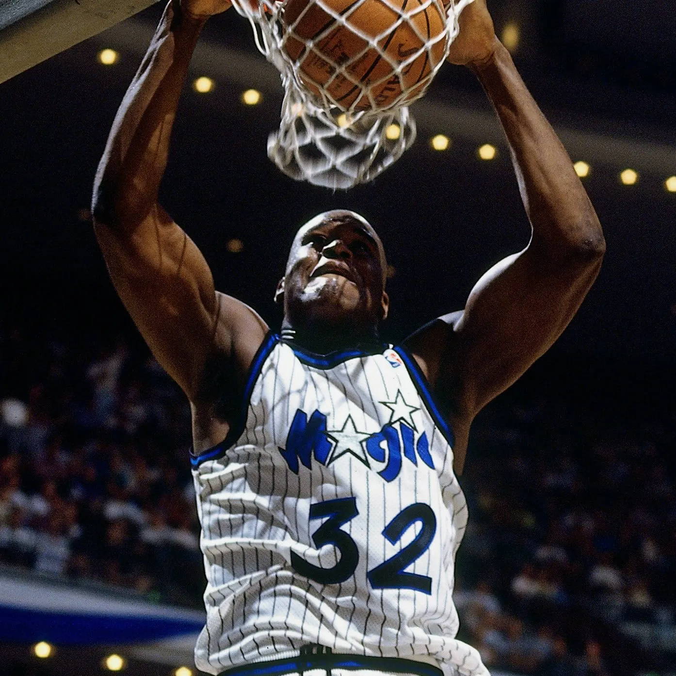 Shaq dunks a basketball