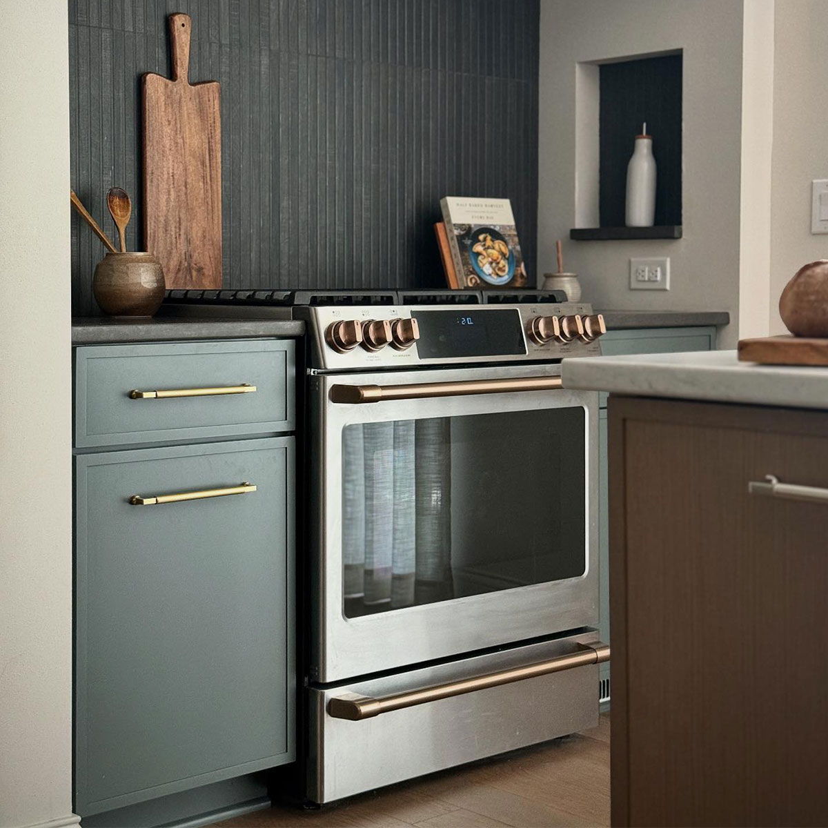Stainless Steel Range with brushed brass hardware in duotone kitchen