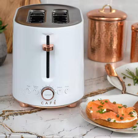 bagel with cream cheese and lox next to toaster