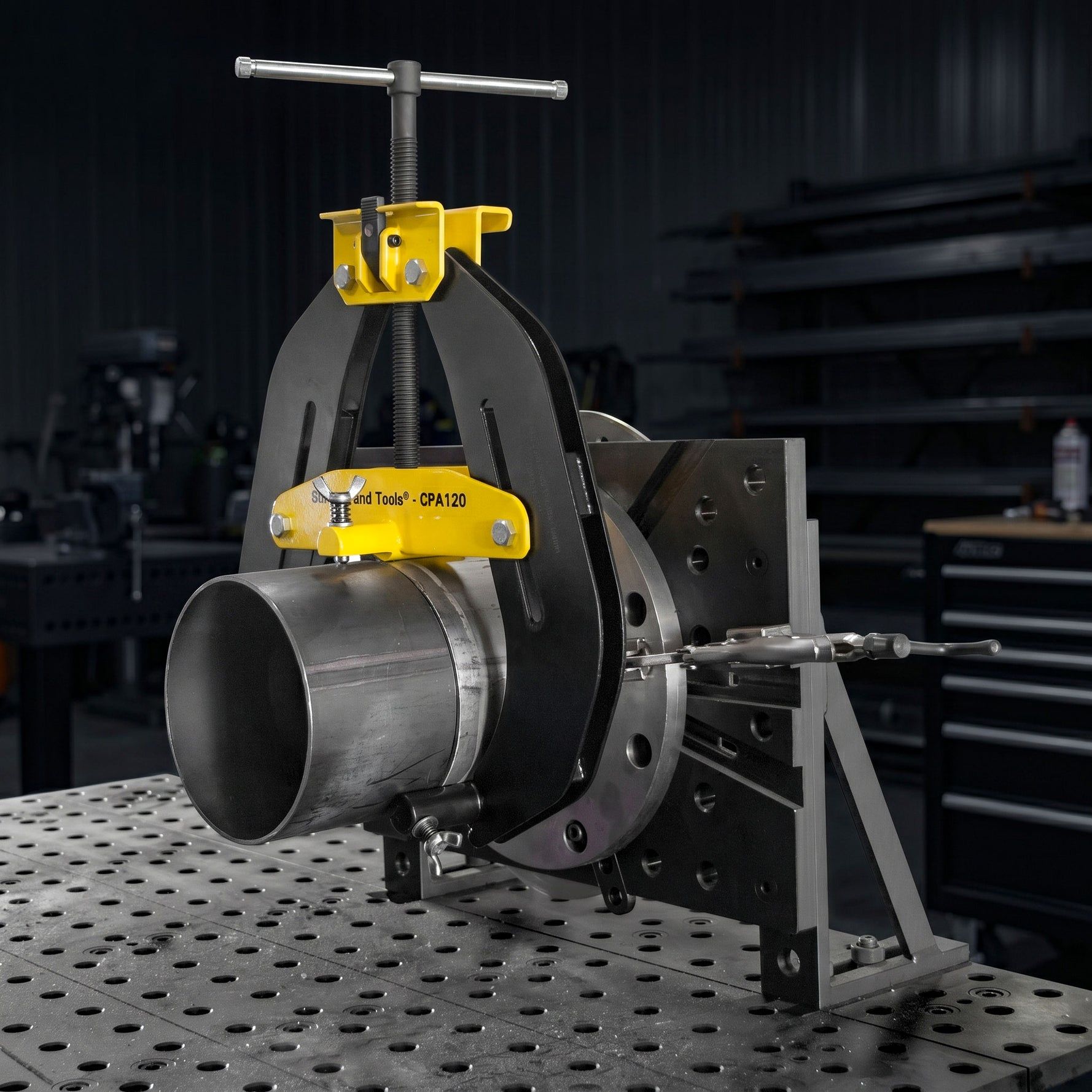 A specialized tool for holding and manipulating cylindrical metal workpieces.