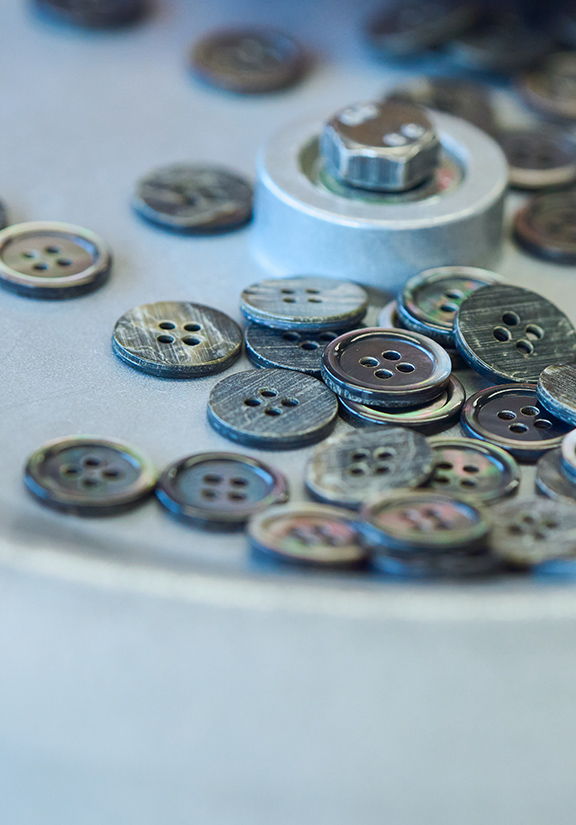 A collection of assorted buttons scattered on a surface.