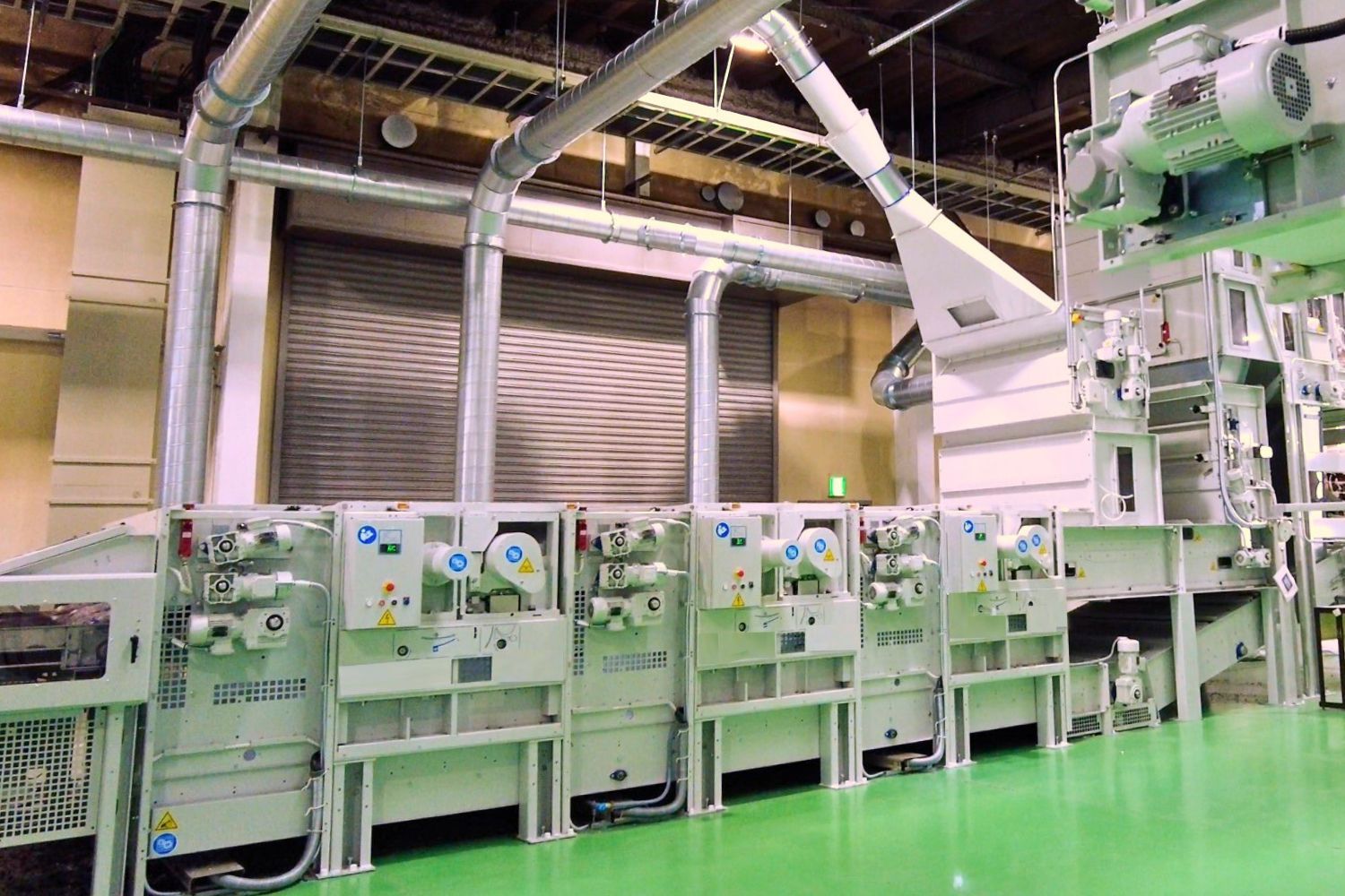 Industrial machinery with pipes and controls in a factory setting.