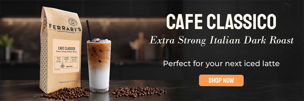 Ferrari’s Café Classico extra-strong Italian dark roast coffee beans with a refreshing iced latte on a black marble counter