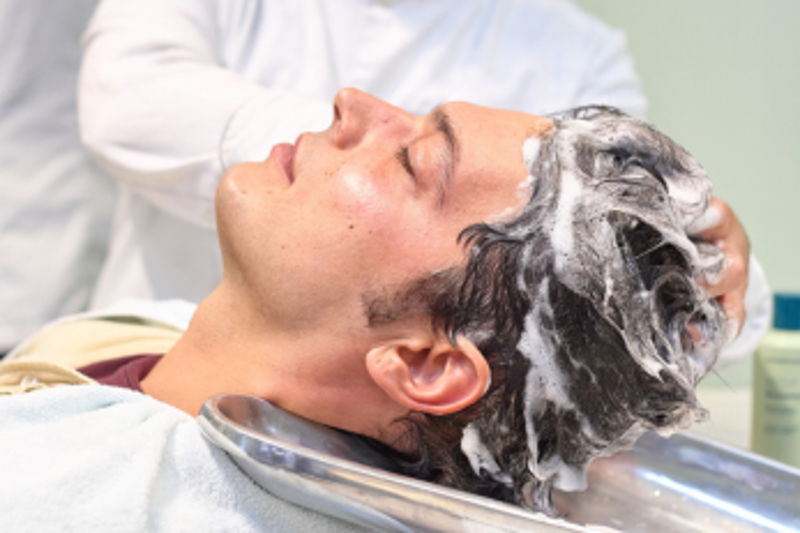 Barber washing a guest's hair