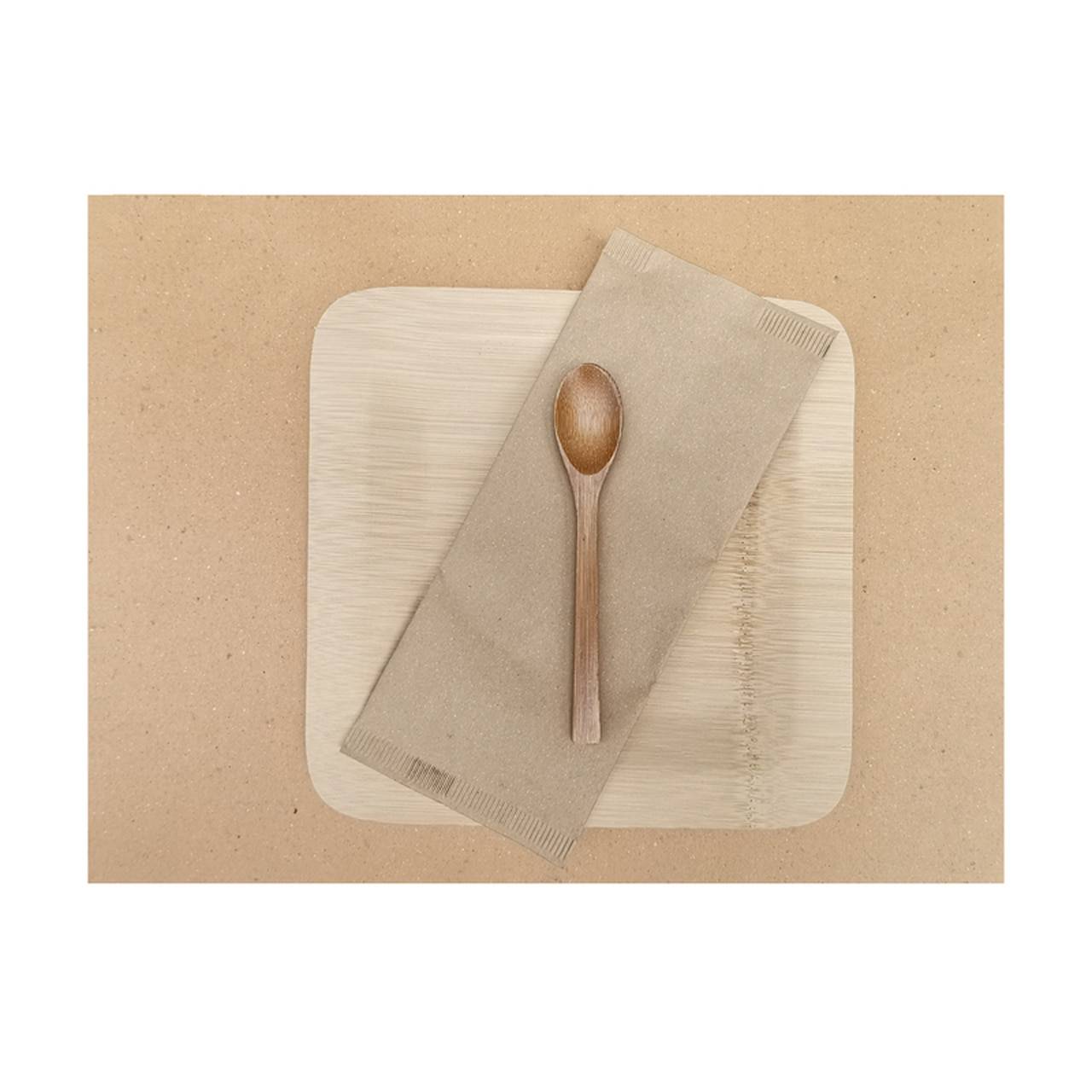 A brown paper placemat with a plate and spoon on top