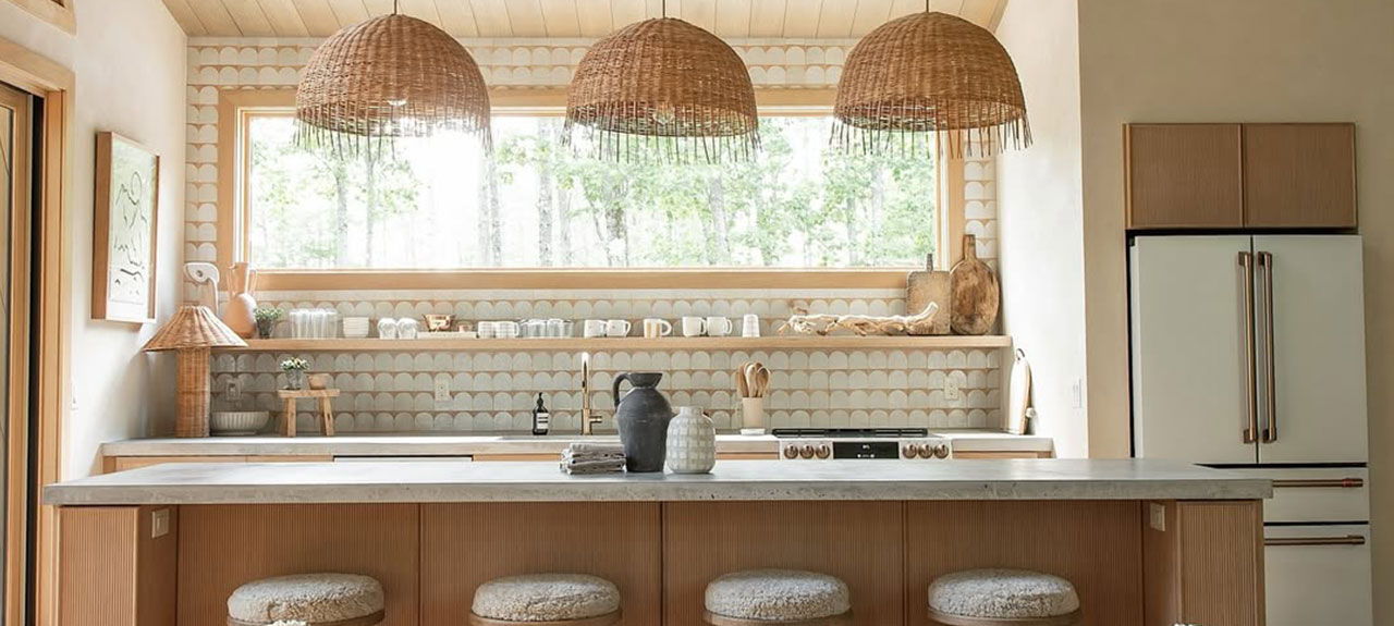 Bright, warm kitchen with wooden accents, matte white appliances, and pendant lighting.