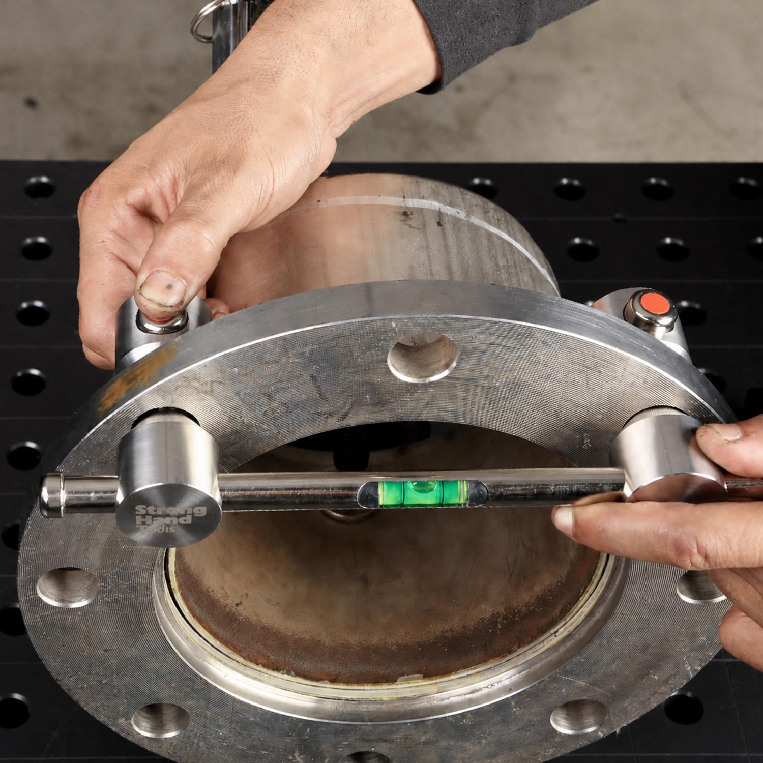 Person using a tool to measure a metal component.