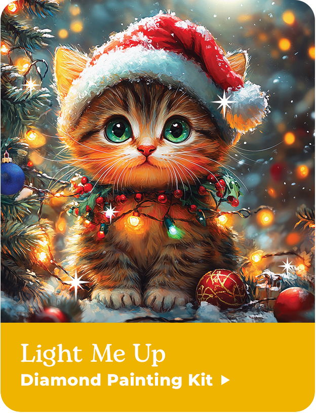A cute kitten wearing a Santa hat surrounded by Christmas lights and ornaments. Light Me Up Diamond Painting Kit.